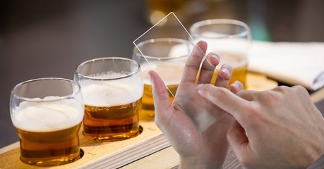 Hands taking picture of beer glasses 