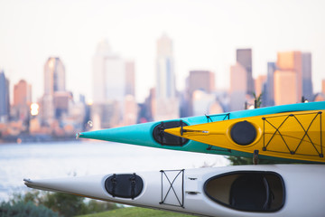 Kayaks stacked on rack on background of Seattle downtown