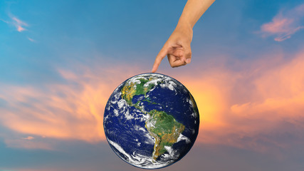 Holding a glowing earth globe in his hands. Earth image provided by Nasa