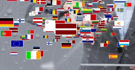 Digital composite image of various flags against businesswoman