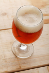 Red ale on light wood