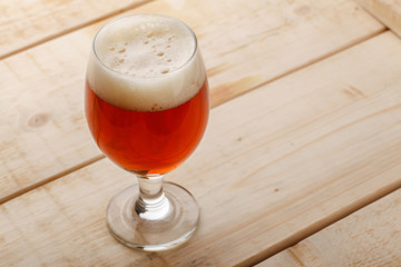 Red ale on light wood