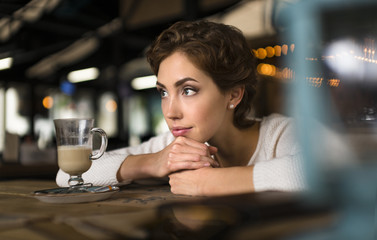 Young woman in the cafe. Dreaming about love.