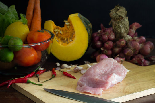 Pork and vegetables prepared for cooking on the table in the kitchen / Still life image and select focus..