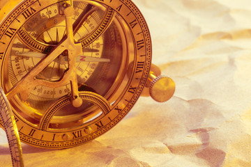 antique compass on vintage paper background