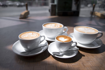 Coffee cups of different size with pattern on surface