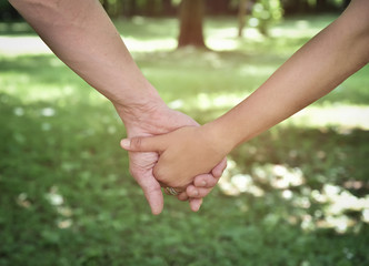 Couple in love walking in the park and holding hands