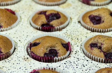 Delicious Muffins with cherry baked in the pan. Closeup