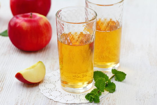 Apple juice and apples on the table