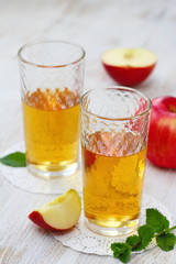 Apple juice and apples on the table