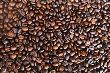 Coffee beans background. roasted coffee beans, can be used as a background. Close up and Macro.