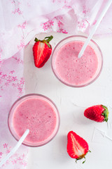 Milk cocktail with strawberries, top view