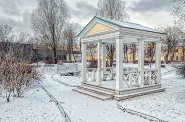 A bridge and a gazebo in the Polish Garden in winter.
