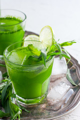 Homemade lemonade from fresh tarthun with lime in glass glasses, selective focus