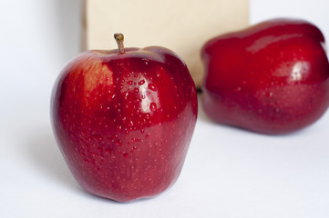 two apples with brown bag