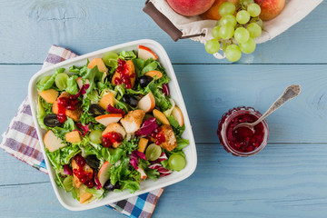 French salad with baked camembert, cranberries and fresh fruit.