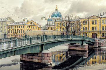 Fototapeta na wymiar The Krasnoarmeyskiy (Red Army) bridge and The Trinity Cathedral in the distance.