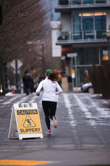 Woman runner running in the street of urban city