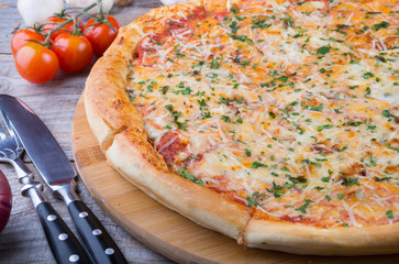 Whole baked pizza on a board