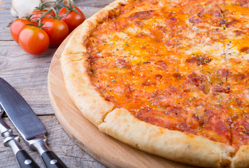 Whole baked pizza on a board