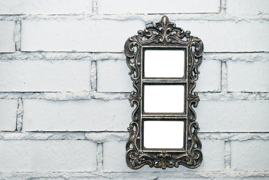 empty frame on a white brick wall