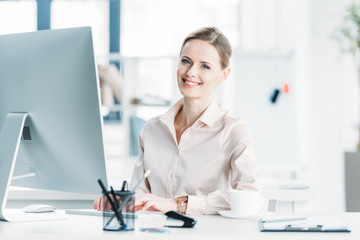 young caucasian businesswoman working on computer at modern office