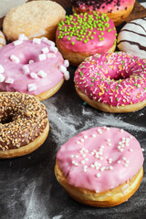 Donuts in a glaze assorted on a black background