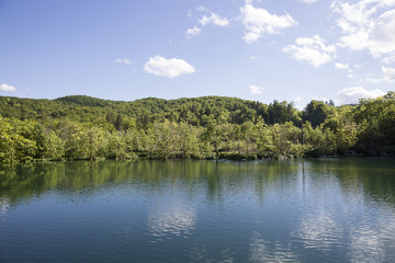 Landscape with beautiful luxuriant nature, lake and blue sky with clouds at  "Plitvice Lakes" National Park, Croatia