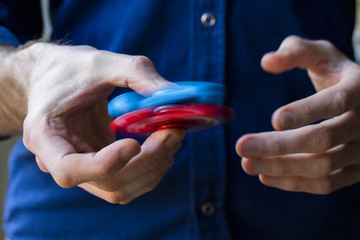A person holding popular fidget spinner toy