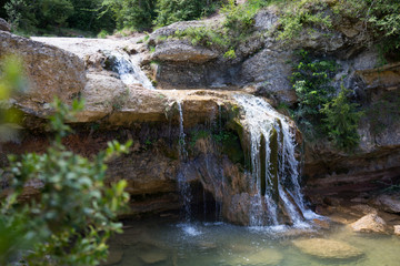 Fototapeta na wymiar Pure mountain creek with green water