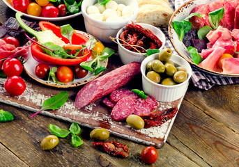 Appetizer set. Meat, vegetables on wooden board.