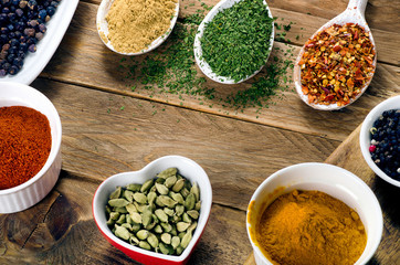 Various colorful spices on wooden table