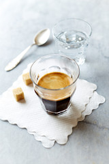 Glass of Espresso and a Glass of Water on gray marble background