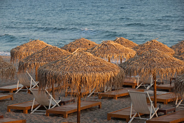 Beach chairs and umbrellas on the beach.