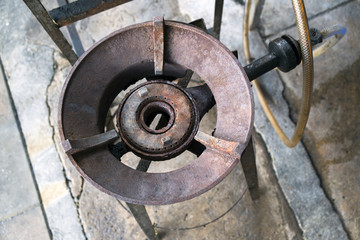 big gas brazier, old and grunge big vintage gas stove on the floor in the asian resturant kitchen.
