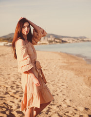  Beautiful woman,posing in boho style beach dress near the sea