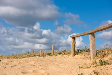 Fototapeta na wymiar Wooden fence on Atlantic beach in France
