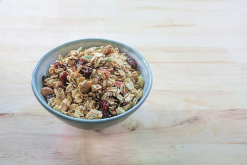 Granola in bowl on wooden background