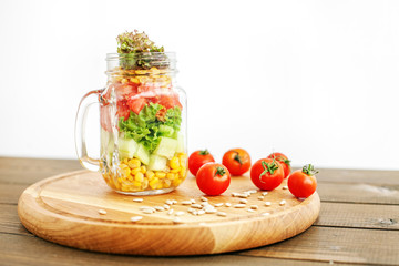 Salad mix with tomatoes and cucumbers and corn on the table. Healthy food, Diet, Detox, Clean Eating or Vegetarian concept