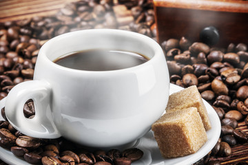 Cup with hot coffee and sugar on the table