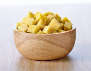 ginger sliced in wood bowl