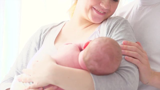 Happy young family. Father, mother and their newborn baby. Parenthood concept. 3840X2160 4K UHD video