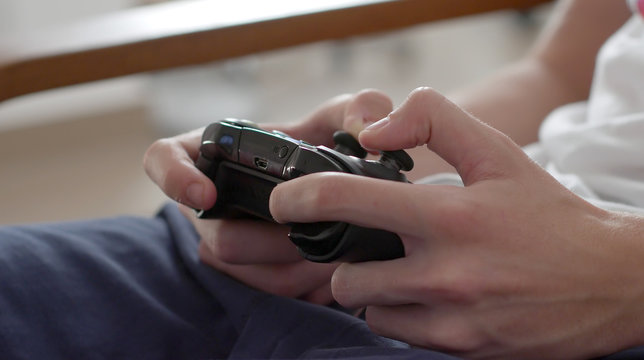 Close up of boy hands using game controller, in the end throwing the controller, angry close up