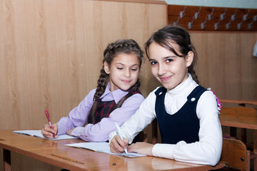 Little girl with pigtails smiling in class
