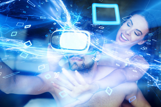 Couple playing virtual reality by headset at home in cyberspace