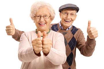 Overjoyed seniors holding their thumbs up