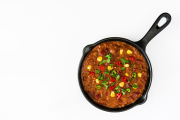 Traditional mexican tex mex chili con carne in a frying pan isolated on white background
