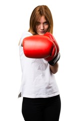 Beautiful young girl with boxing gloves