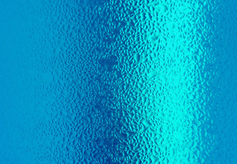 Macro shot of water drops texture on vivid blue color bottle, for abstract background with selective focus 