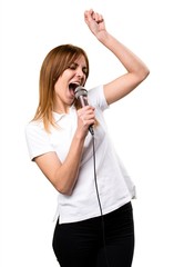 Beautiful young girl singing with microphone